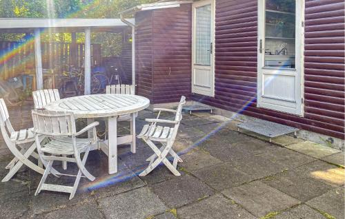 a table and chairs on a patio with a house at Lovely Home In Egå With Wifi in Egå