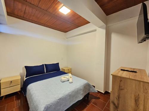 a bedroom with a bed and a television in it at Hotel Finca Recreacional La Fortaleza 