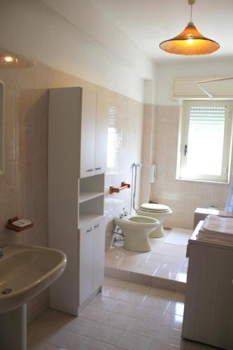 a bathroom with a sink and a toilet and a sink at Halicia Vacanze in Salemi