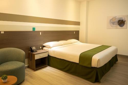 Un ou plusieurs lits dans un hébergement de l'établissement Hotel Cultura Plaza
