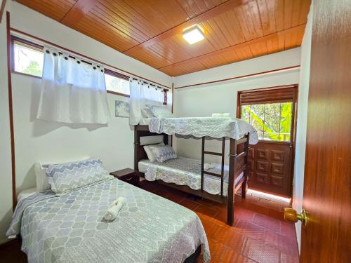 a bedroom with two bunk beds and a window at Hotel Finca Recreacional La Fortaleza 