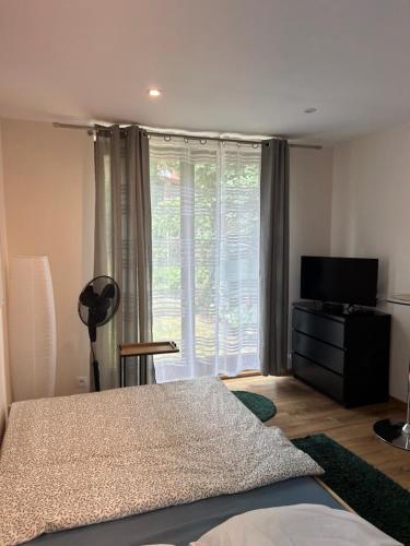 a bedroom with a bed and a large window at Studio na Krzykach in Wrocław
