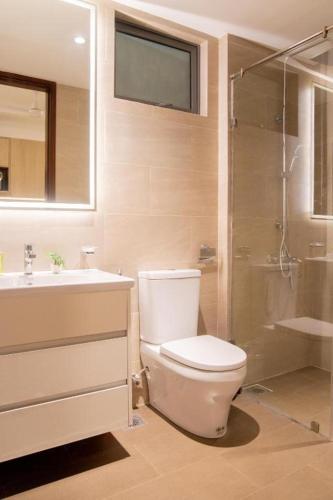 a bathroom with a toilet and a sink and a shower at Spacious 3BR Luxury Apartment Trizen Colombo 2 Near City Centre in Colombo