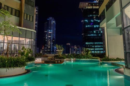 a swimming pool in the middle of a city at night at Spacious 3BR Luxury Apartment Trizen Colombo 2 Near City Centre in Colombo