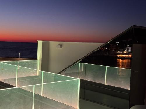 a glass house with a view of the ocean at Attico sul Mare - Suite & Spa in Palermo