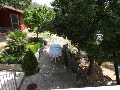 a table and chair sitting in a garden at Apartment in Malinska I in Malinska