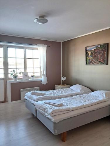 a bedroom with a large bed and a window at Furudals Bruk in Furudals Bruk