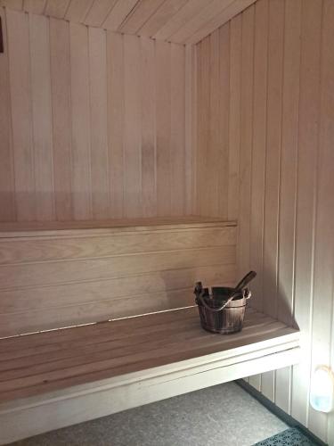a sauna with a basket on a wooden shelf at Furudals Bruk in Furudals Bruk