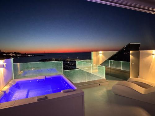 a jacuzzi tub in a room with a view at Attico sul Mare - Suite & Spa in Palermo