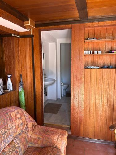 a bedroom with a door leading to a bathroom at Ara Gesa Old Cottage in Curtina