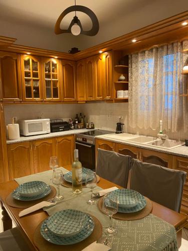a kitchen with a table with plates and wine glasses at Deppy's House in Naousa