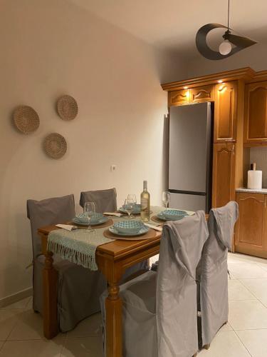 a kitchen with a table with chairs and a refrigerator at Deppy's House in Naousa