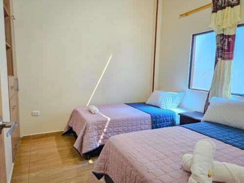 a room with two beds and a window at Hotel Finca Recreacional La Fortaleza 
