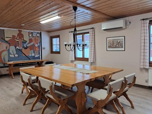a dining room with a wooden table and chairs at Furudals Bruk in Furudals Bruk
