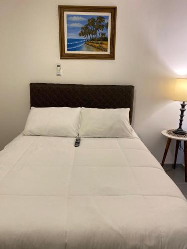 a bedroom with a bed with a white bedspread at Apartamento completamente equipado! in Encarnación