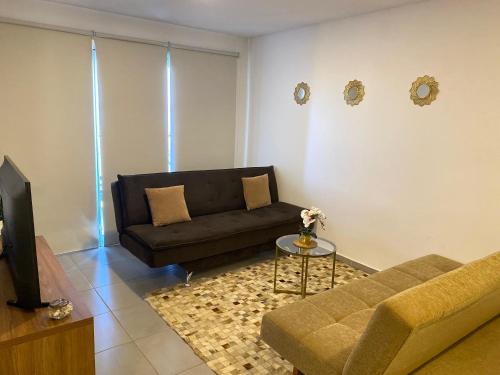 a living room with a couch and a table at Apartamento completamente equipado! in Encarnación