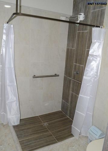 a shower with a glass door in a bathroom at Mi pequeño hostal in Santa Rosa de Cabal