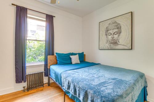 a bedroom with a bed with blue sheets and a window at 2 Mi to Rainbow Beach Park South Side Charmer! in Chicago