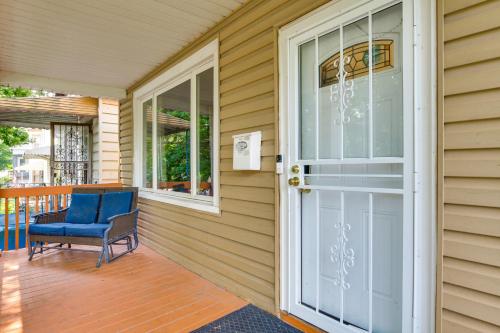 a porch with a blue chair and a door at 2 Mi to Rainbow Beach Park South Side Charmer! in Chicago
