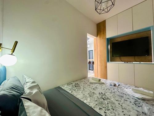 a room with a couch and a tv and a bed at Adriatic Dream in Tivat
