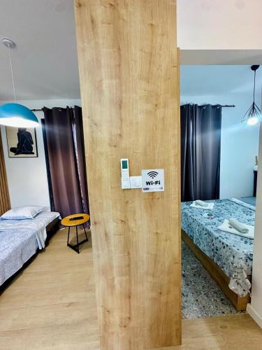 a room with two beds and a sign on a wall at Adriatic Dream in Tivat