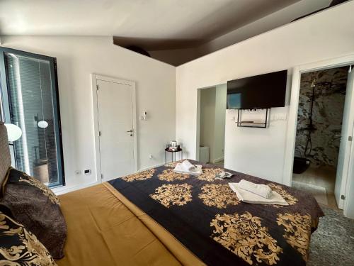 a bedroom with a bed and a tv on the wall at Adriatic Dream in Tivat