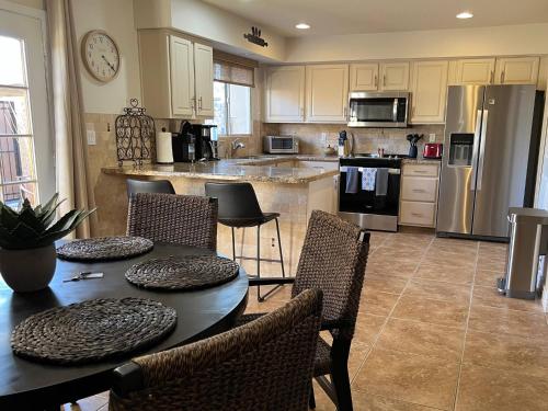 a kitchen with a table and chairs and a refrigerator at Osborn Oasis | Short Walk to Old Town Scottsdale in Scottsdale