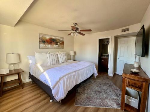 a bedroom with a bed and a ceiling fan at Osborn Oasis | Short Walk to Old Town Scottsdale in Scottsdale