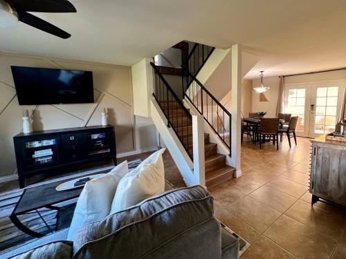 a living room with a couch and a tv at Osborn Oasis | Short Walk to Old Town Scottsdale in Scottsdale