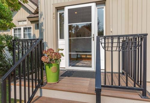 a front door of a house with a vase of flowers at Aspen Serenity - Hiking - in the Teton Valley in Driggs