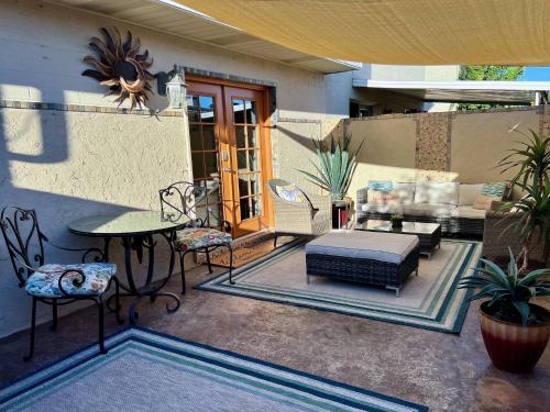 a patio with a table and chairs and a couch at Osborn Oasis | Short Walk to Old Town Scottsdale in Scottsdale