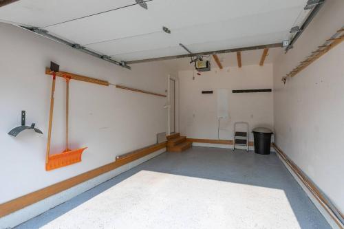 an empty room with a white wall and a chair at Aspen Serenity - Hiking - in the Teton Valley in Driggs