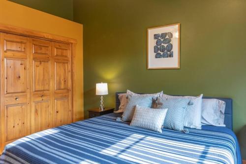a bedroom with a bed with a blue and white comforter at Aspen Serenity - Hiking - in the Teton Valley in Driggs