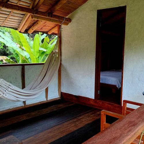 a room with a bed and a hammock in it at Refugio Cumaná Entero in San Rafael