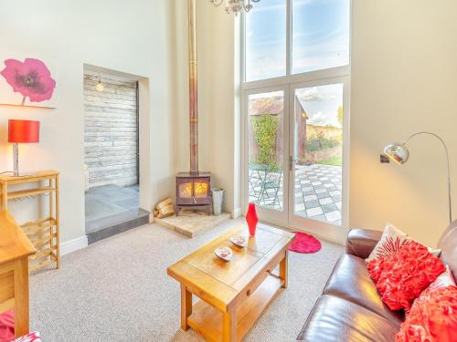 a living room with a couch and a fireplace at Hallmark Lodge in Tenterden