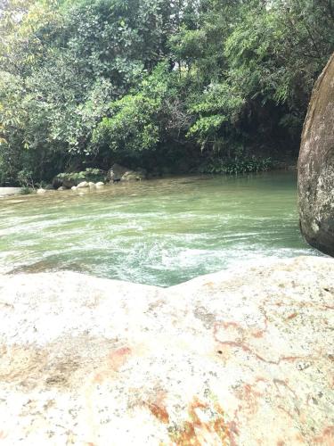 a river with green water and trees in the background at Refugio Cumaná Entero in San Rafael