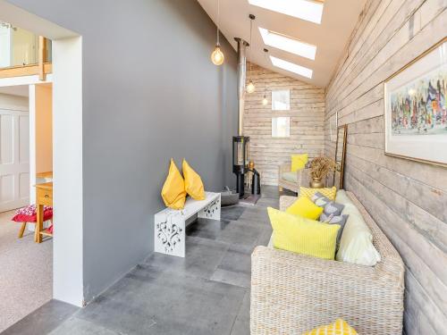 a living room with two couches and yellow pillows at Hallmark Lodge in Tenterden