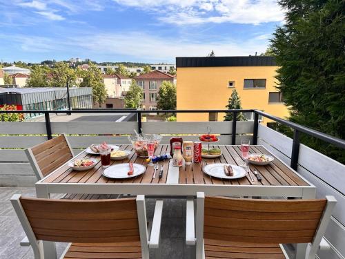a table with plates of food on a balcony at 80qm Luxus Apartment mit großer Terrasse in Saarbrücken