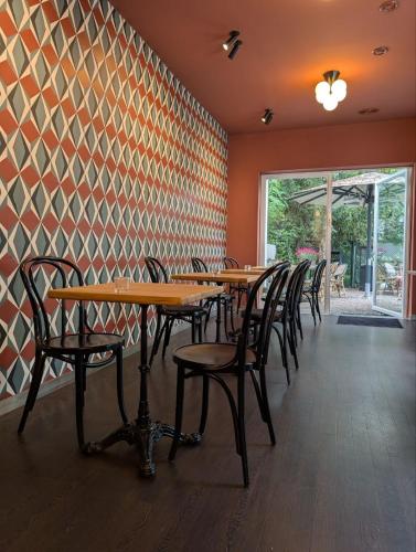 a row of tables and chairs in a restaurant at Aussen Alster Hotel in Hamburg