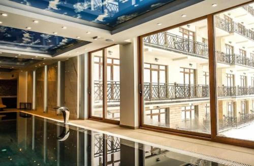 a large room with a swimming pool and large windows at President kop apartment 412 in Kopaonik