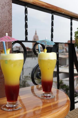 two drinks on a table with umbrellas at Hotel Don Pedro De Heredia in Cartagena de Indias