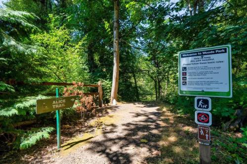 a sign on a trail in a forest with trees at Forest Studio Oasis - Mile from Multnomah Village in Portland