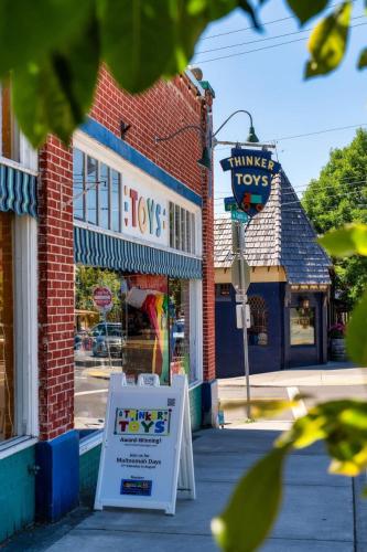 a sign in front of a store on a street at Forest Studio Oasis - Mile from Multnomah Village in Portland