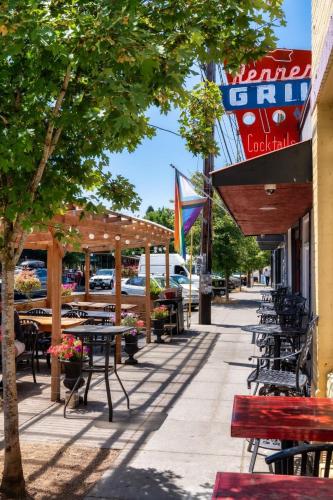 a sidewalk with tables and chairs and a restaurant at Forest Studio Oasis - Mile from Multnomah Village in Portland