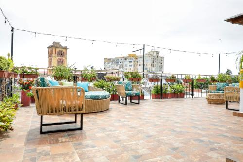 a patio with chairs and tables on a roof at Hotel Don Pedro De Heredia in Cartagena de Indias