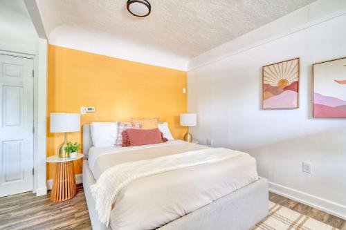 a bedroom with a large bed and a yellow wall at Forest Studio Retreat - Near Multnomah Village in Portland