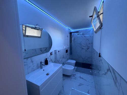 a white bathroom with a sink and a toilet at ARDELEAN Apartments - Palazzo ARDELEAN, Conselice in Conselice