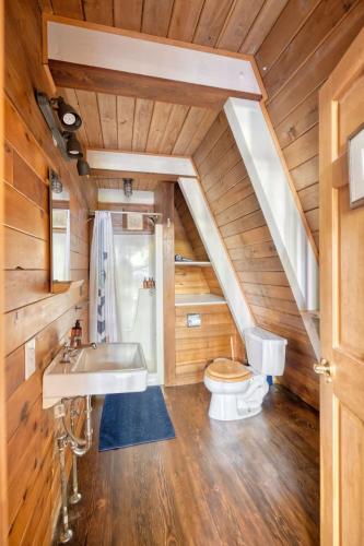 a bathroom with a sink and a toilet at Modern A-Frame Cabin in the Woods in Rhododendron