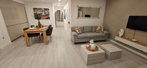 a living room with a couch and a table at River View Tavira - New Listing, Newly Renovated in Tavira