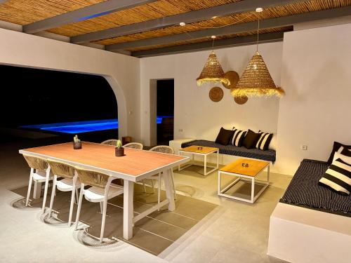 a living room with a table and a couch at Faragas Hill Euphoria Villa in Angairiá